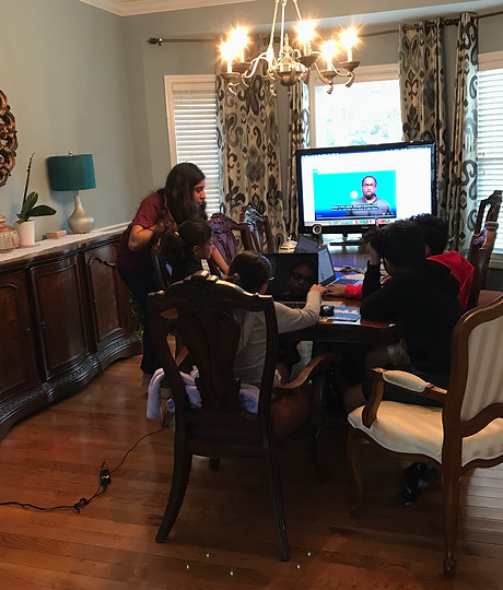 A CodifyKids class in session while the WCIA news segment plays on the TV